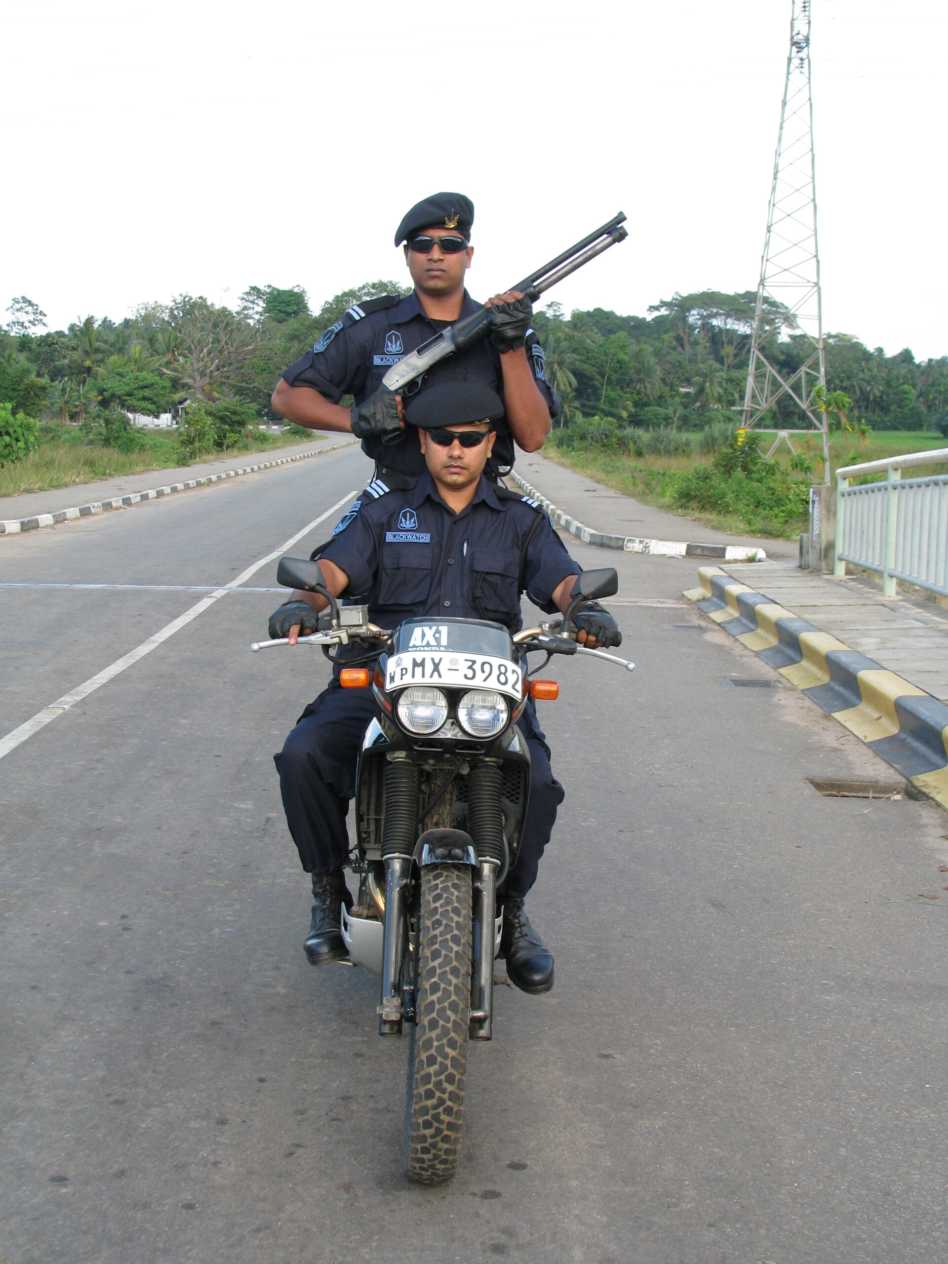 Two guards on motorcycle